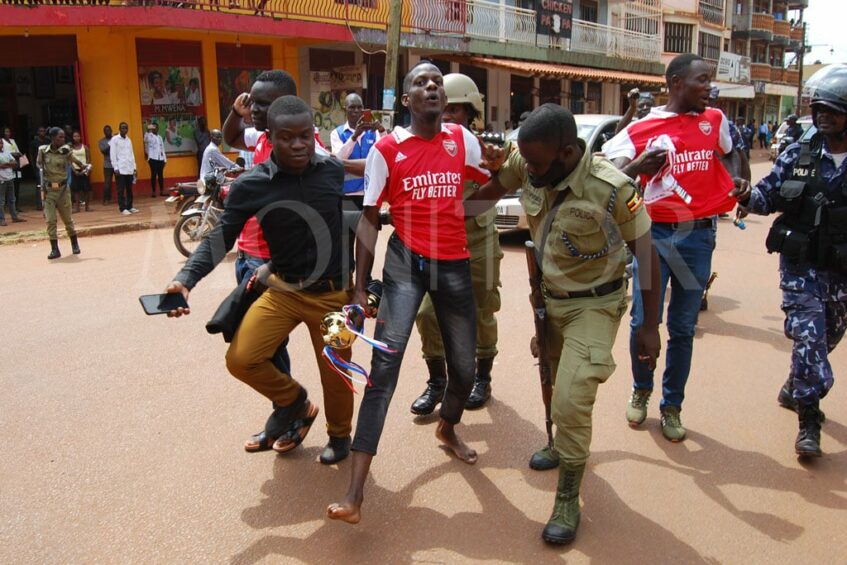 Police officers arrest an Arsenal supporter who was involved in 'premier league' trophy parade in Jinja on January 23, 2023. (Photo: Philip Wafula/Daily Monitor).